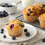 Freshly baked Bisquick Blueberry Muffins with golden tops and juicy blueberries.